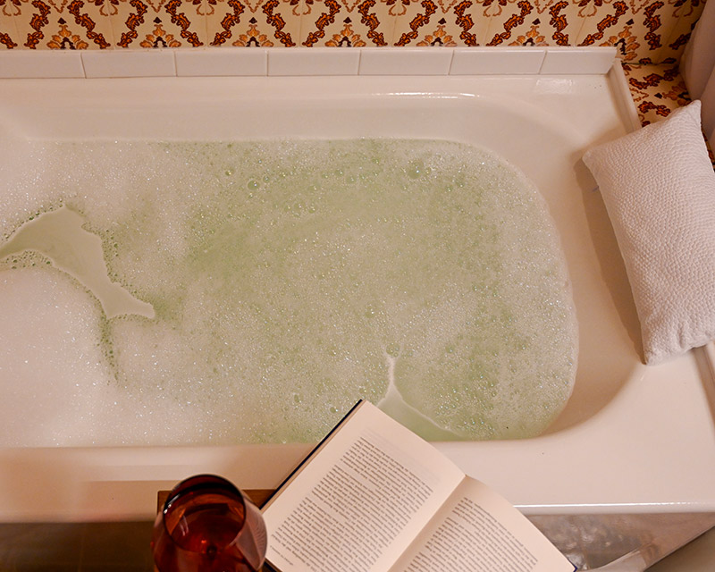Soothing bubble bath with a glass of wine and a good book at Hacienda Eterna Primavera.