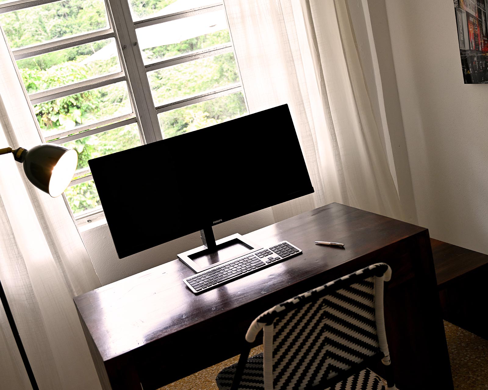 Remote work desk with large screen, natural light, and mountain view at Hacienda Eterna Primavera in Puerto Rico