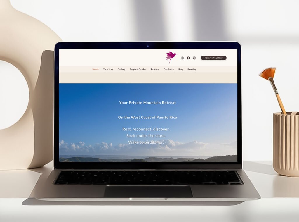 Laptop mockup displaying the updated Hacienda Eterna Primavera website with a blue mountain view hero image.