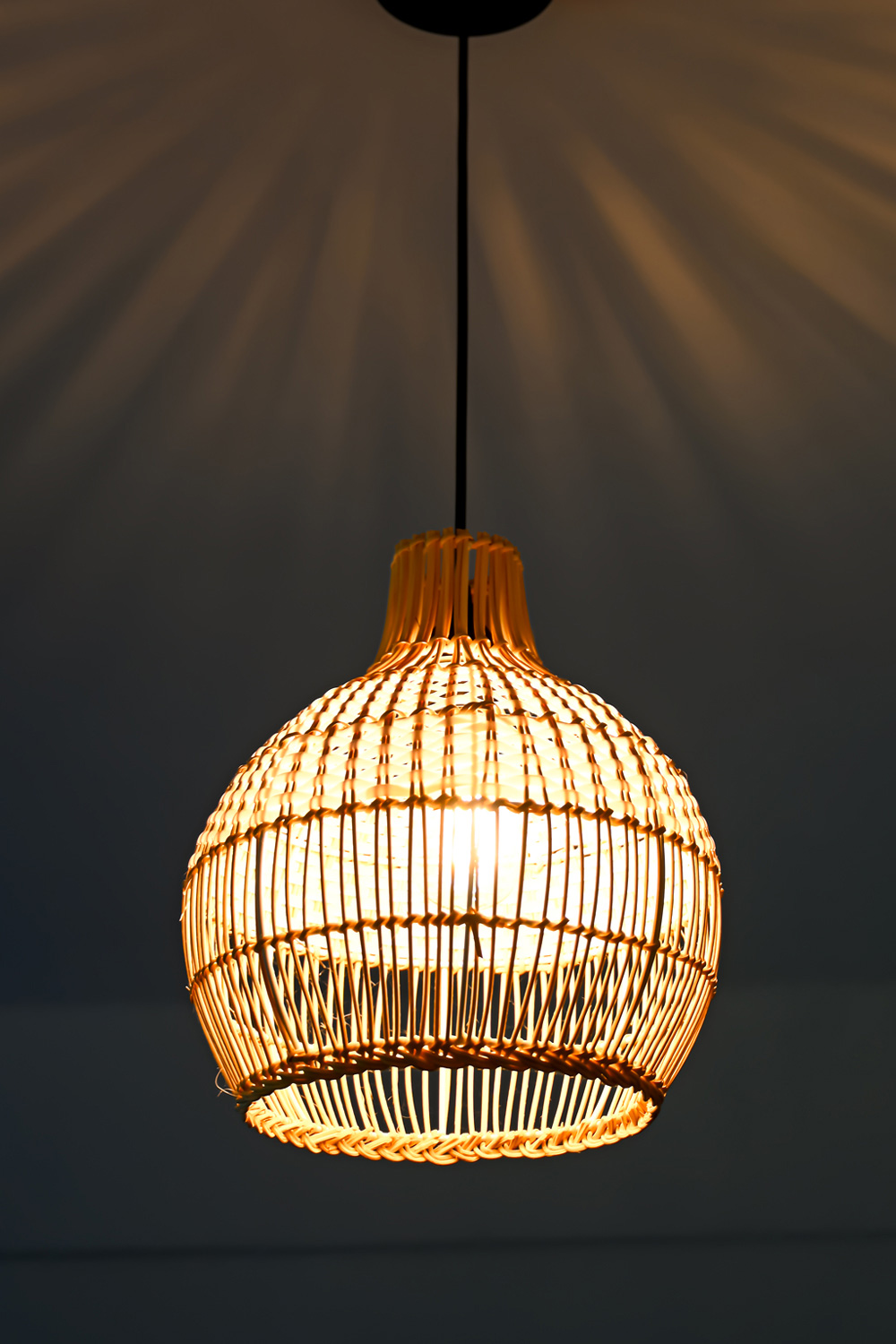 Warm woven pendant light illuminating the cozy interior