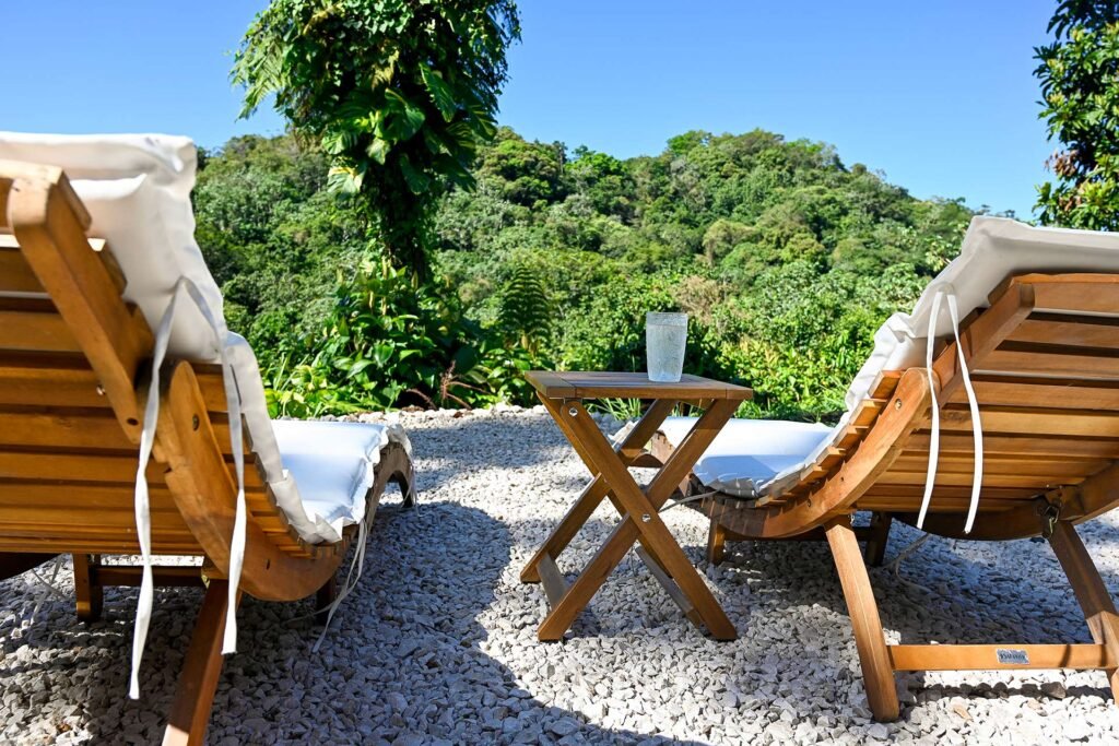Wooden sun loungers overlooking green mountain scenery in Puerto Rico’s interior, set in a quiet natural setting