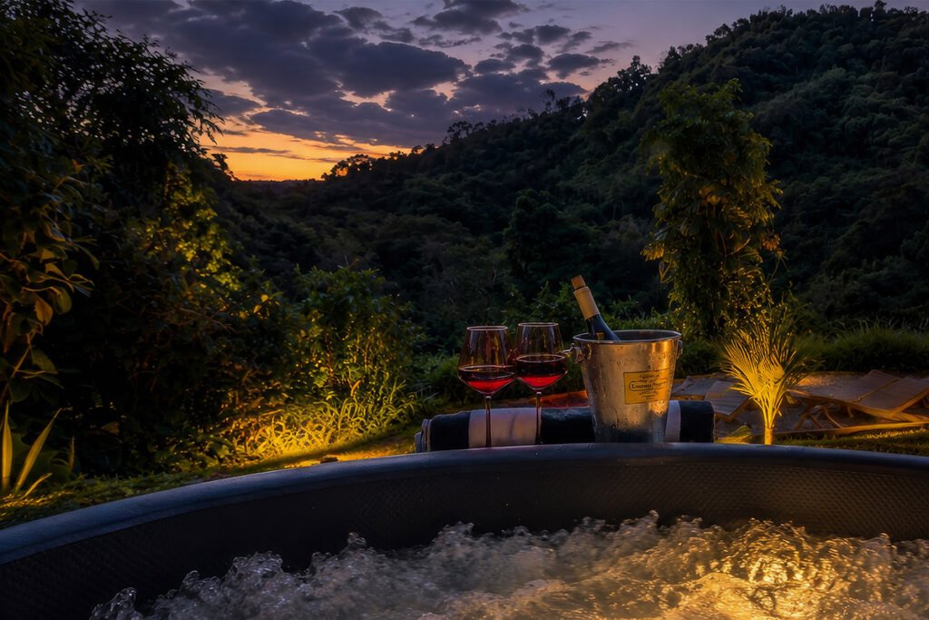 Private jacuzzi with sunset mountain views at Hacienda Eterna Primavera, a secluded nature retreat in Puerto Rico.