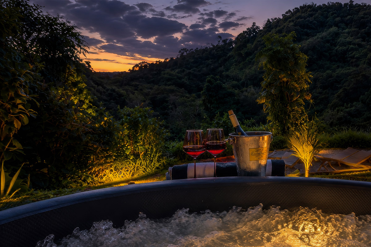 Private jacuzzi with sunset mountain views at Hacienda Eterna Primavera, a secluded nature retreat in Puerto Rico.